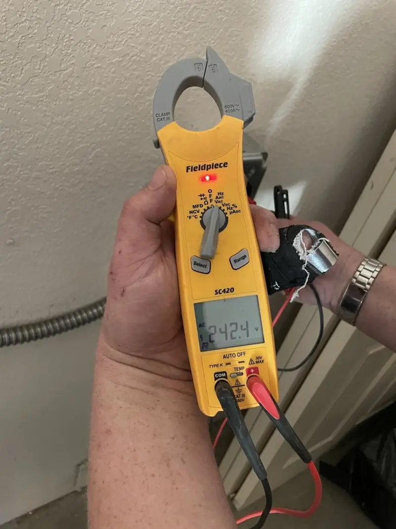 Voltage testing with clamp meter during Electrical Installation Services in Barnesville